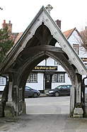 The George, in Dorchester on Thames, seen through the lych gate of the ancient abbey. Dorchester and the surrounding area has been much used in...